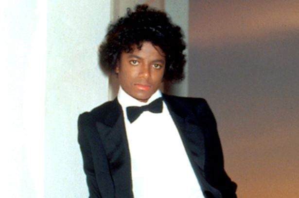 Michael leaning against a wall during the Off the Wall cover shoot at the Griffith Observatory