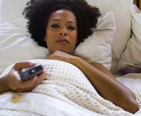 black-woman-in-bed-watching-tv