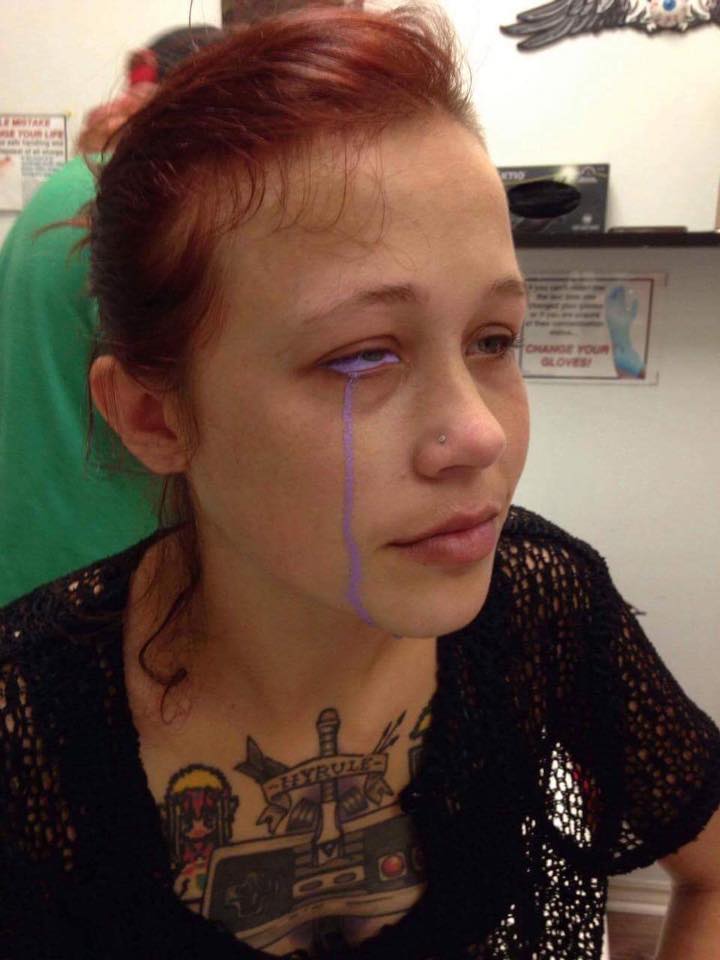 Woman tattoos eye