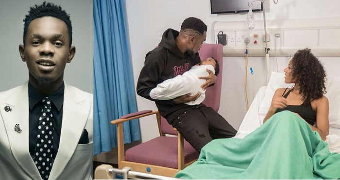 Patoranking Shares Adorable Photo Of Himself Carrying His New Born Baby With His Baby Mam By His Side.