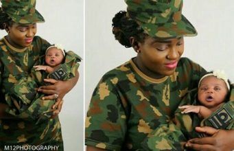 Female Nigerian soldier cradling