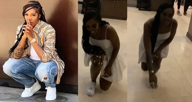 Tiwa Savage kneels
