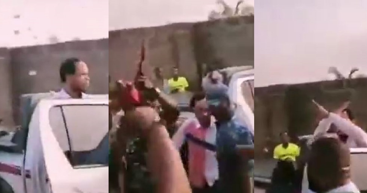 Policemen fire gunshot into the air as clergyman, Odumeje Indaboski throws naira notes into the air