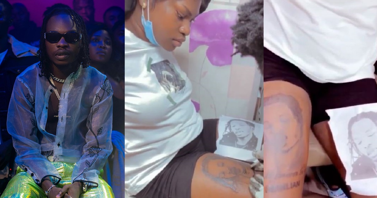 “Kobo you no go see” – Lady dragged for getting tattoo of Naira Marley on her lap