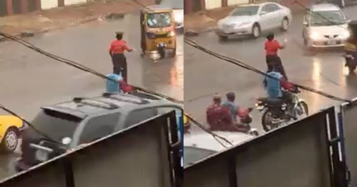 Traffic warden goes viral after seen controlling traffic under the rain in Ilorin (video)