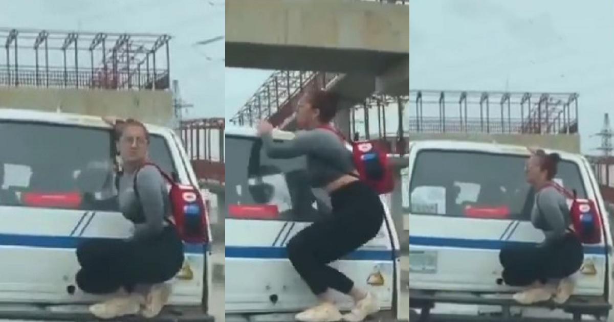 White woman spotted hanging on the back of a moving bus in Lagos (Video)