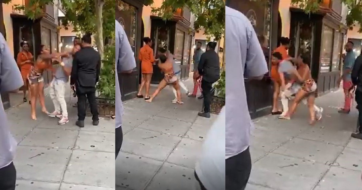 Lady throws several punches at her alleged boyfriend while onlookers watch (Video)