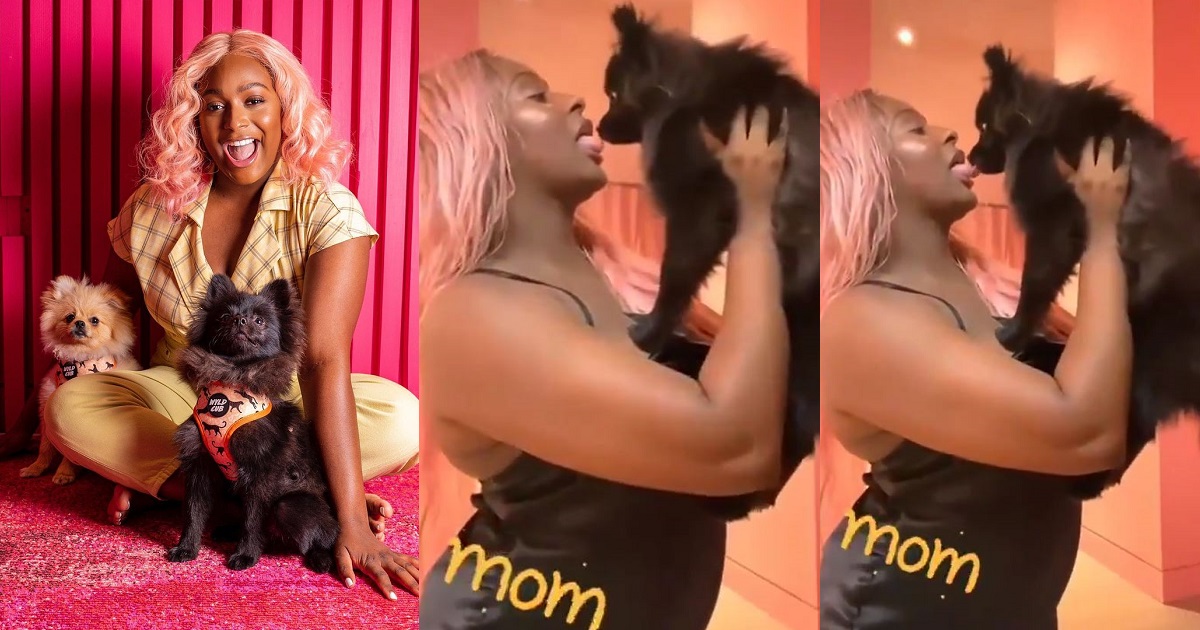 Nigerians react to video of billionaire daughter, DJ Cuppy tongue kissing her dog (WATCH)