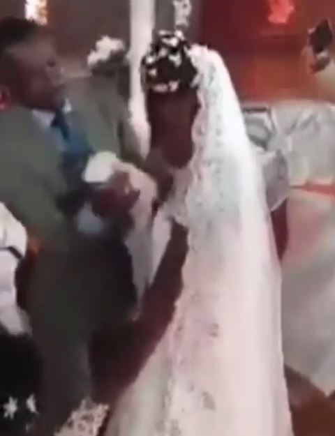 Pastor wipes off bride’s makeup at the altar, then makes bridesmaid scrape off her nail polish with a scissors(video) 3 Pastor wipes