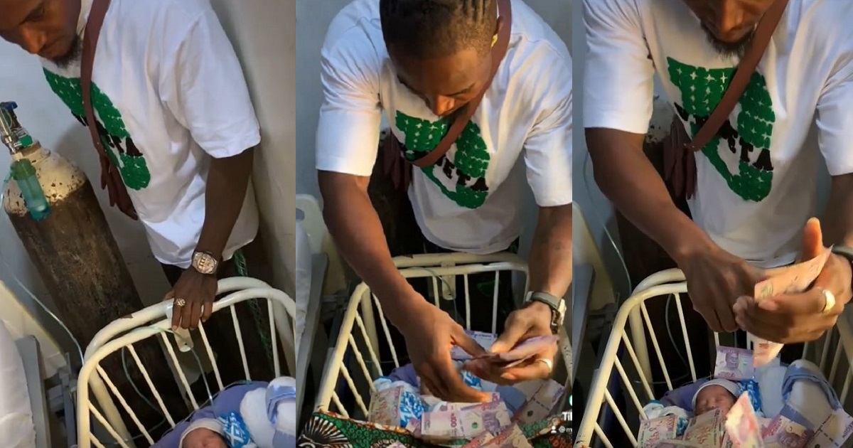“This is senseless and unhealthy” – New dad comes under fire for spraying his newborn with naira notes (video)