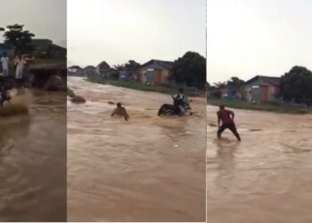 Bike rider swept away by flood after he refused to let go of his bike (video)