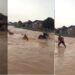 Bike rider swept away by flood after he refused to let go of his bike (video)