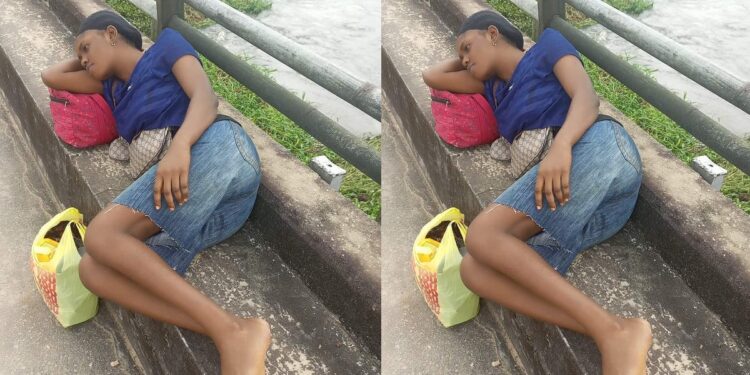 Young woman sleeps on top of bridge as flood renders residents homeless in Bayelsa community (Photo)