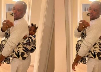 “UK will humble you” – Nigerian man says as he backs his child while wife is at work