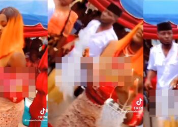 Woman spotted rubbing a bride’s face with money (video)