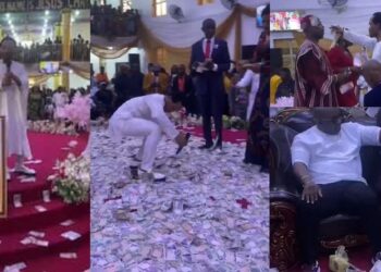 “Is this pleasing to God?” – Netizens chides Prophet Odumeje over video of his members making money rain on the altar during his birthday celebration (Watch)