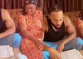 Singer, Flavour warms hearts with video of him reading Bible verse to his mum during devotion (Watch)