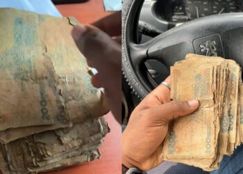 Nigerian man shows the N200 notes given to him at the bank (Photos)