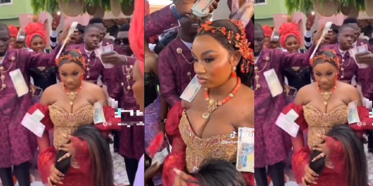 “I would never smile again” – Reactions as beautiful bride not allowed to smile until groom sprays enough money