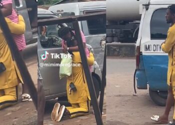 Nigerian man goes down on his knees in motor park to propose to his girlfriend (Video)