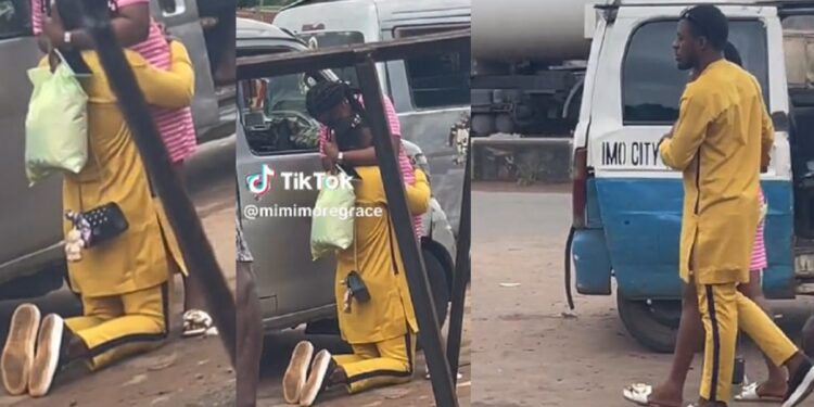 Nigerian man goes down on his knees in motor park to propose to his girlfriend (Video)