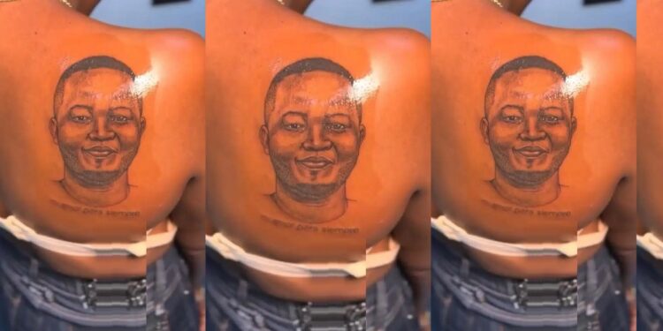 “When them break up she go cut that place comot” – Reactions as lady tattoos her boyfriend’s face on her back