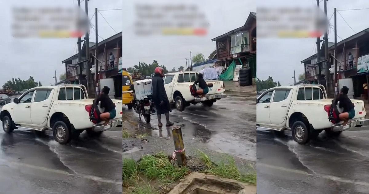 “When you are going to office and you don’t want to get wet” – Reaction as lady grabs onto a moving vehicle in an attempt to cross a flooded road (VIDEO)