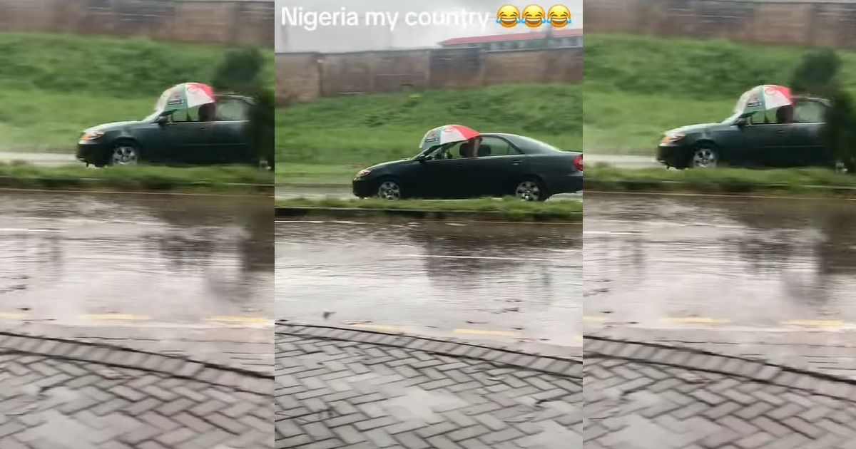 “The glass no fit wind up be that” – Driver refuses to close car window, opts for umbrella in heavy rain (VIDEO)