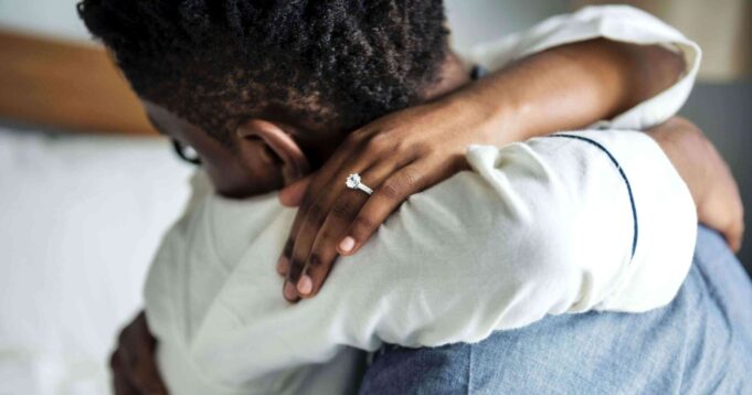 ceee407a7ec58dd857aadd8c58e7ea1e-black-couple-embraces-with-wedding-ring-shown_l