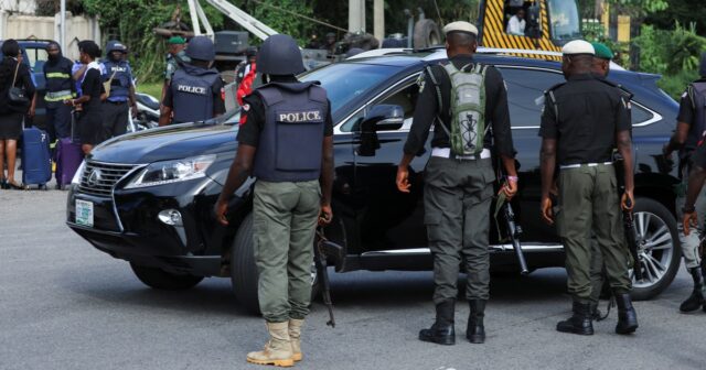 Police officers are seen conducting checks on vehicles at the Federal High court in Abuja