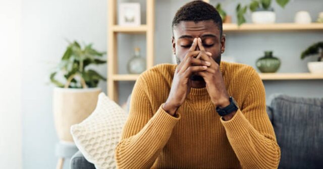 Shot of a young man looking stressed out at home