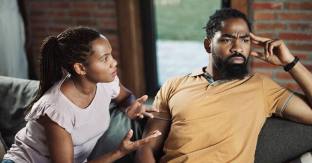 Angry African American woman having an argument with her boyfriend at home