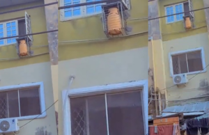 Passerby stunned as a gas cylinder is found secured in an iron cage by a window