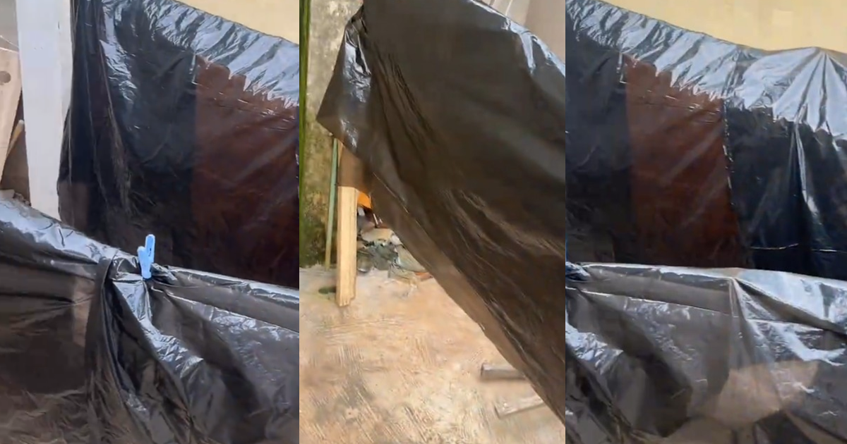 Lady improvises as heavy rain pours after doing her laundry (Watch)