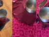 Lady uses cooking pot to iron her outfit, refuses to be disgraced by power outage (WATCH)